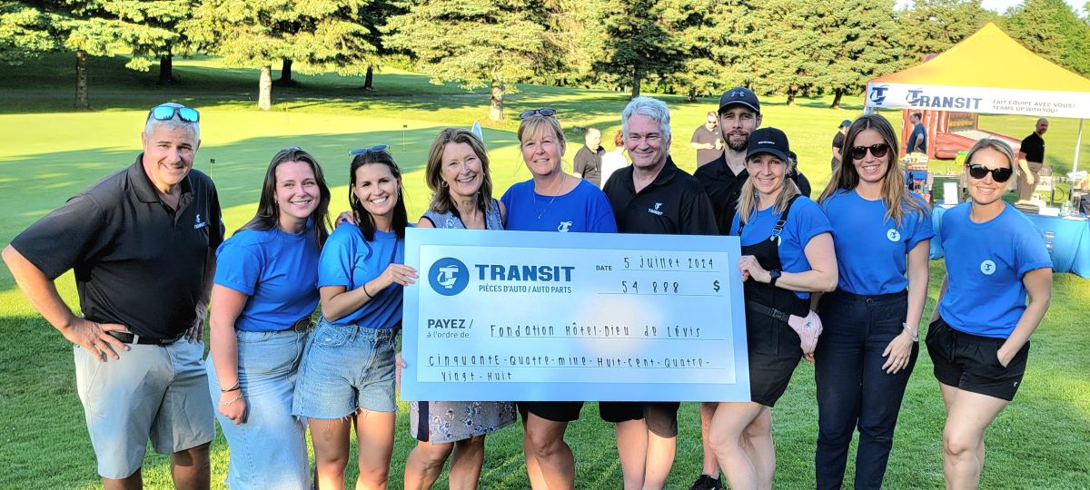 Transit the largest auto parts warehouse in eastern Canada. golfers holding cheque